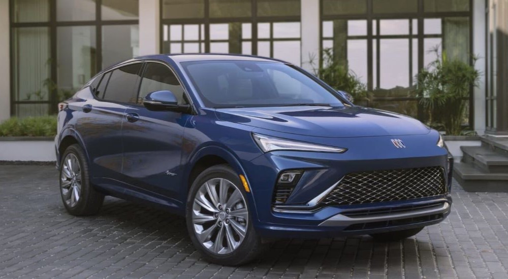 A blue 2024 Buick Envista Avenir is shown parked outside of a Buick dealer near Rochester, MN.