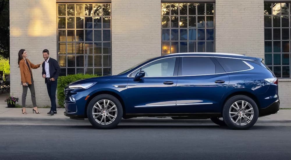 A blue 2024 Buick Enclave is shown from the side after leaving a Buick dealer near Faribault.