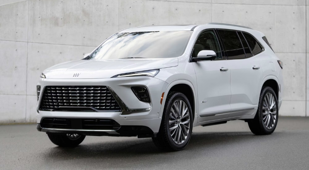 A white 2025 Buick Enclave Avenir is shown at a Buick dealer near Belle Plaine.