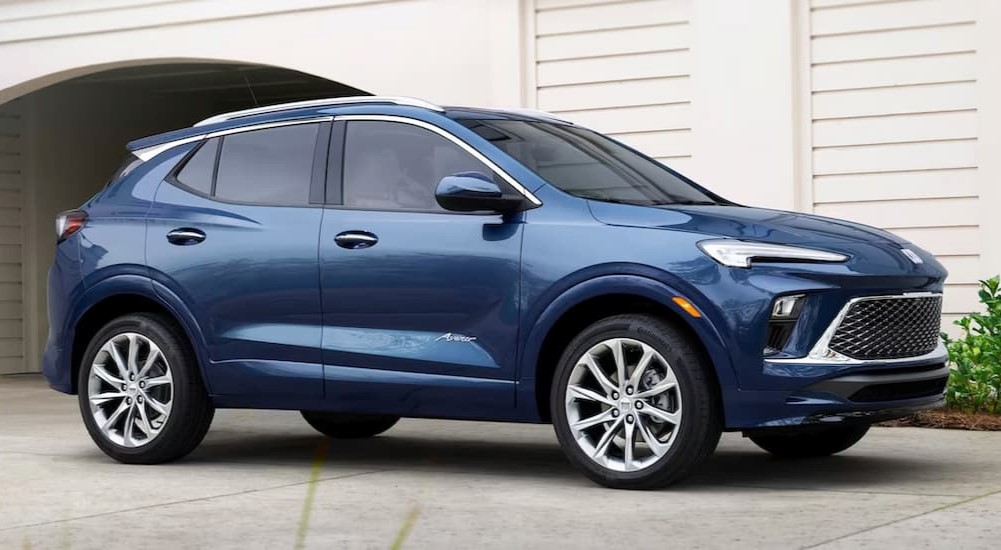 A blue 2024 Buick Encore GX Avenir is parked in a driveway after leaving a Buick dealership near Minneapolis.