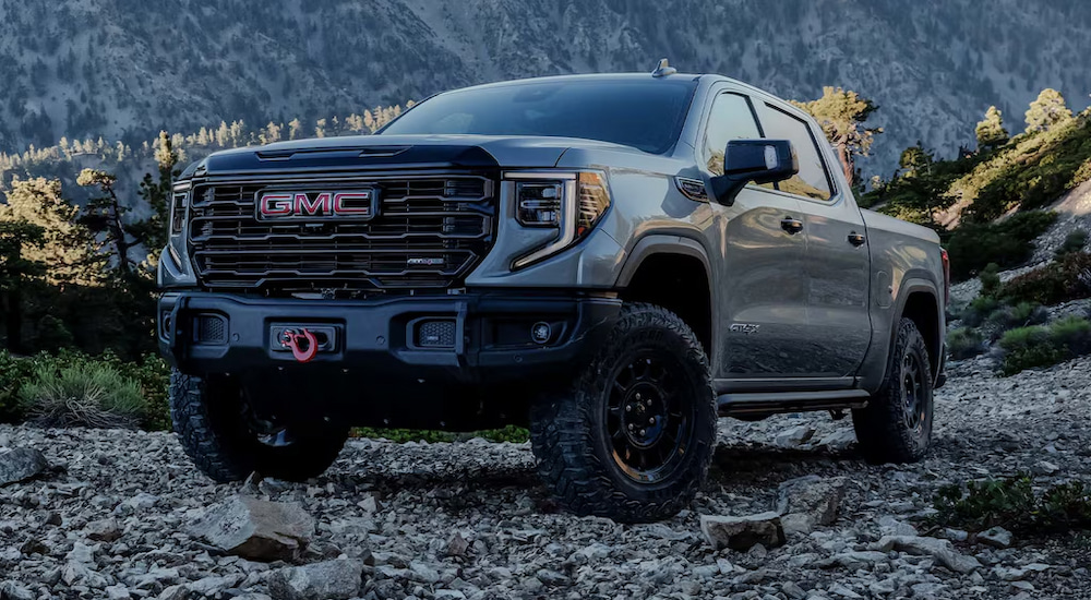 A grey 2025 GMC Sierra 1500 AT4X off-roading in the mountains.
