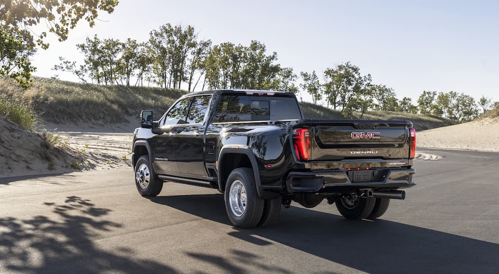 A black 2025 GMC Sierra 3500 Denali is shown from the rear at an angle after leaving a GMC dealer near New Ulm.