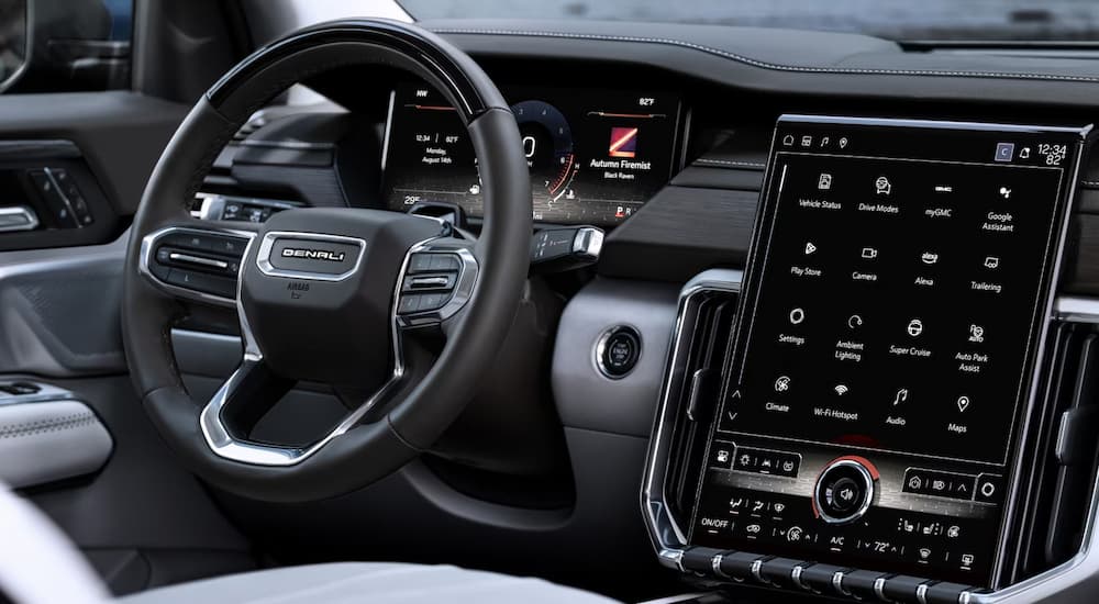 Steering wheel and infotainment screen in a 2025 GMC Acadia at a GMC dealer near New Ulm.