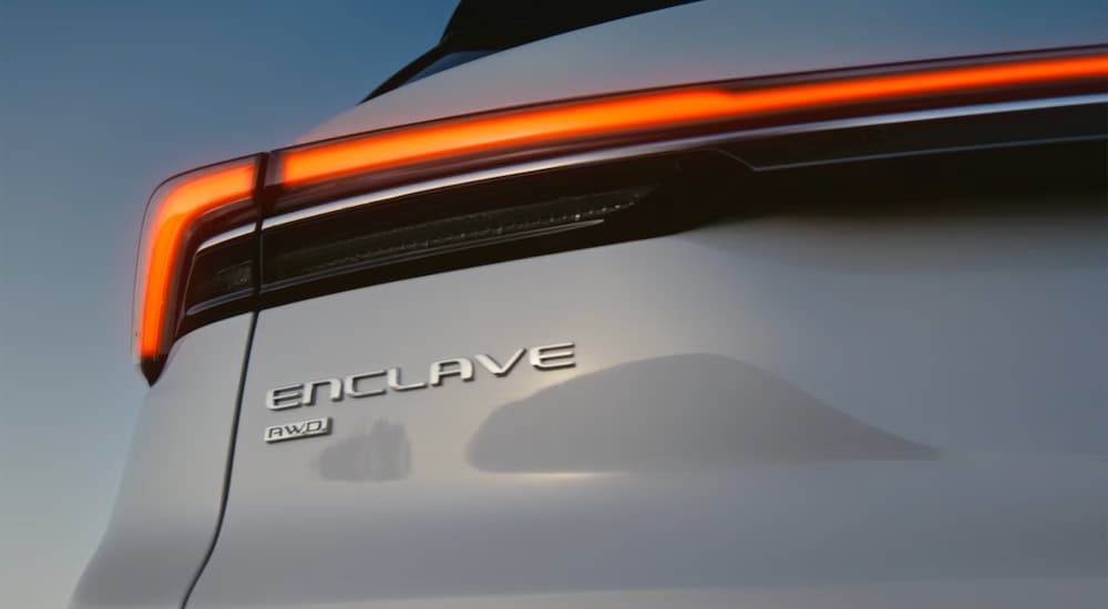 Close-up of the Enclave badge on a silver 2026 Buick Enclave.