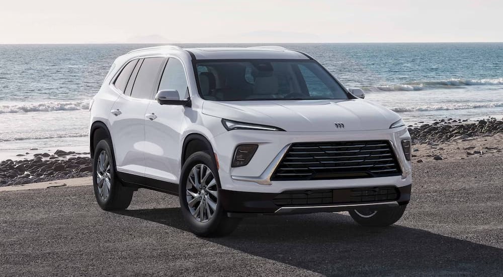 A white 2026 Buick Enclave parked near water.