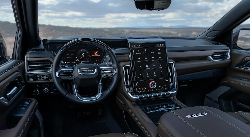 The wheel and infotainment screen in a 2026 GMC Yukon XL Denali.