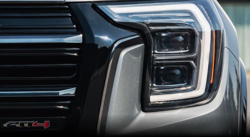 Close-up of a headlight on a white 2026 GMC Terrain AT4.