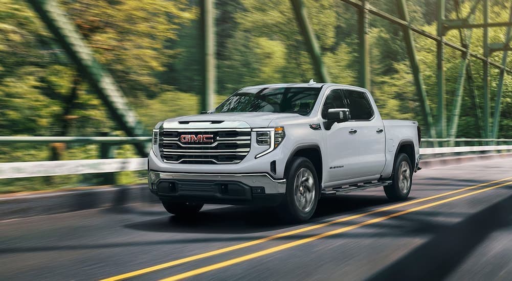 A white 2026 GMC Sierra 1500 driving to view cars for ale in Mankato.
