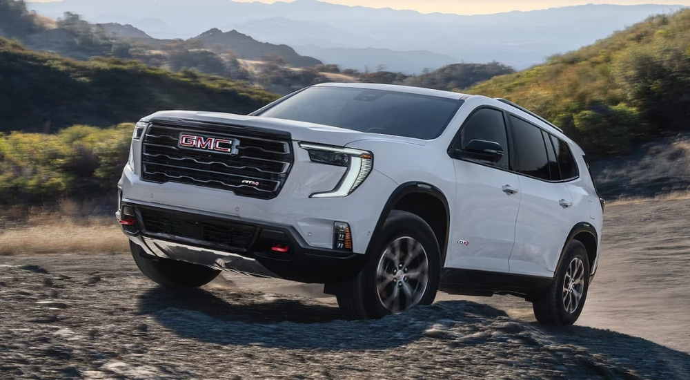 A white 2026 GMC Acadia AT4 off-roading