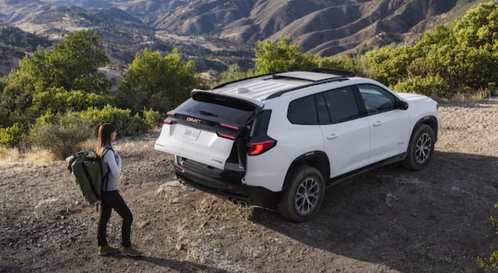 A white 2026 GMC Acadia parked off-road.