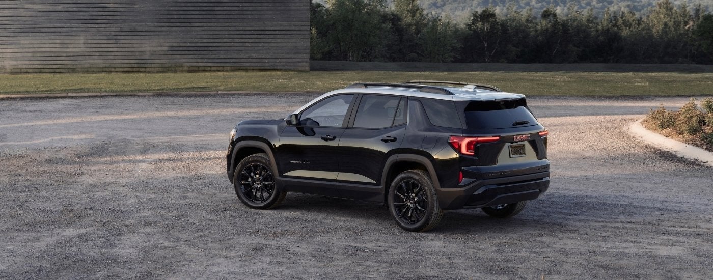 A black 2025 GMC Terrain from the rear at an angle.