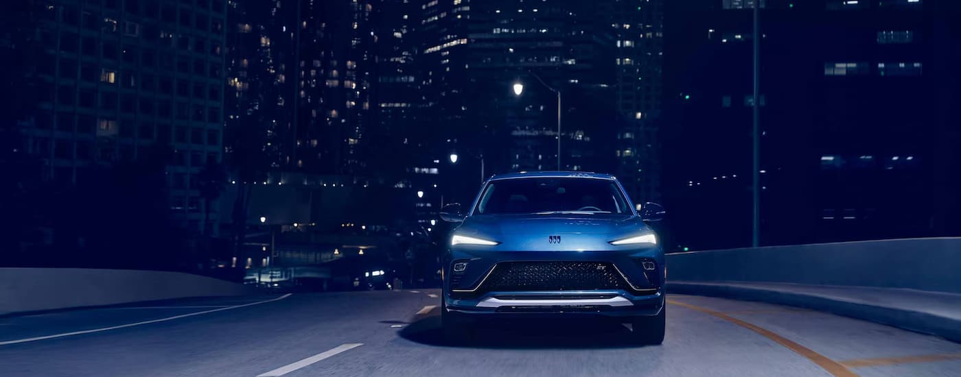 High view of a blue 2026 Buick Envista driving across a bridge