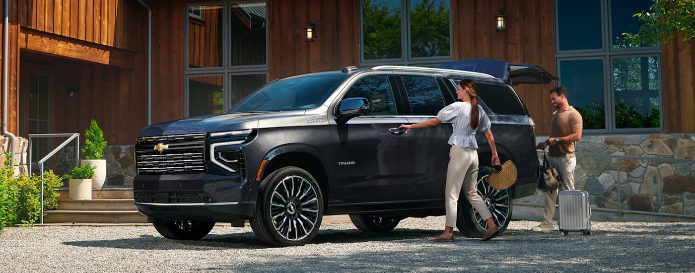 Black 2026 Chevy Tahoe High Country parked outside a building.