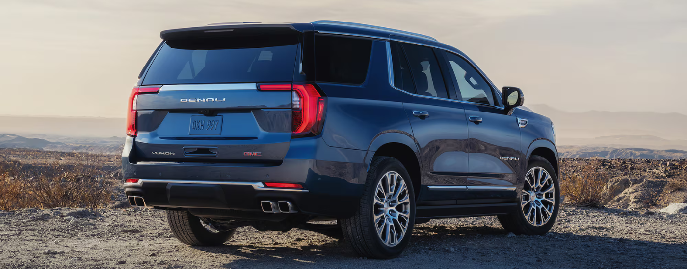 Blue 2026 GMC Yukon parked on a trail