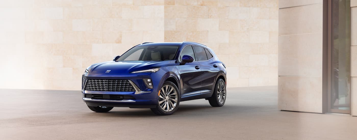 Blue 2026 Buick Envision parked near a white wall.