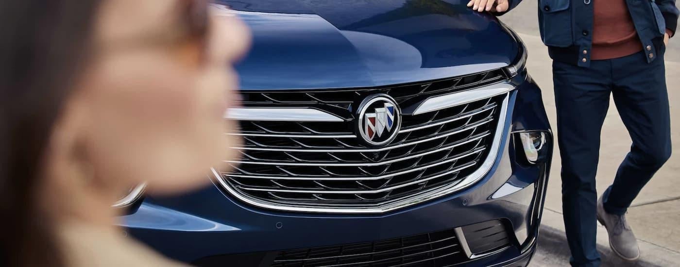 A close up of the front of a blue 2023 Buick Enclave is shown at a Buick dealer.