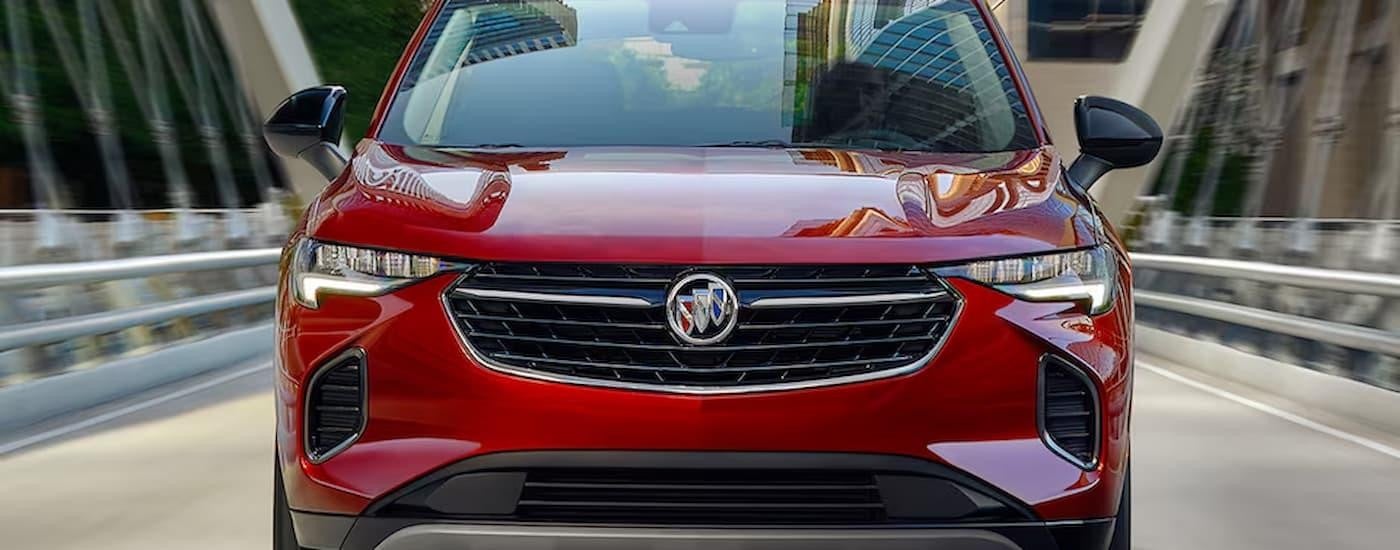 A red 2024 Buick Envision is driving on a highway after leaving a Buick dealer near Belle Plaine.