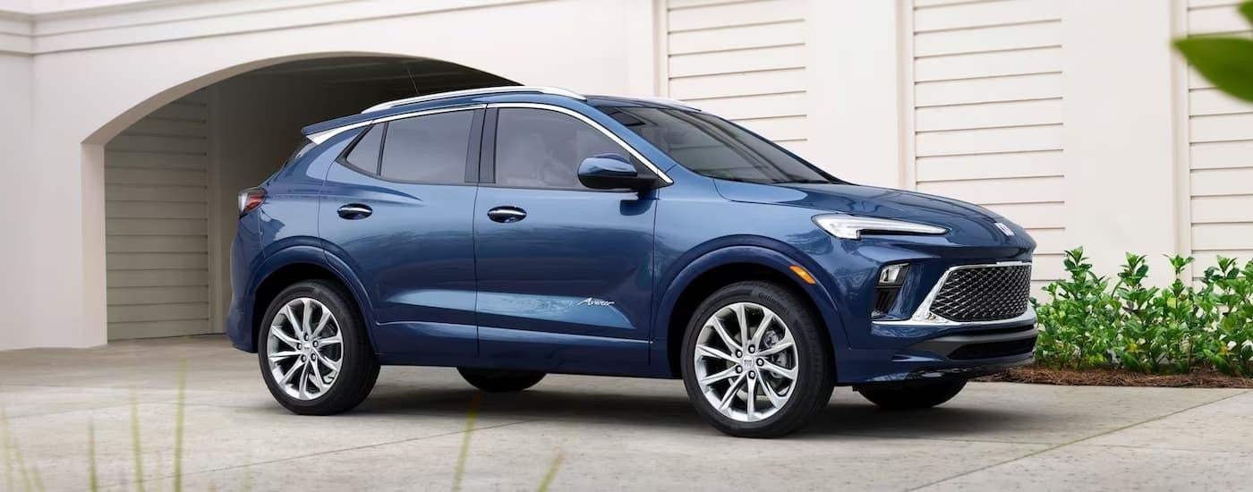 A blue 2024 Buick Encore GX is shown parked in a driveway.