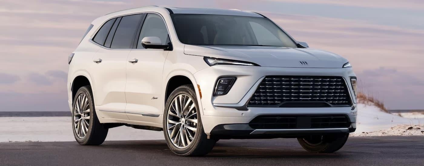 A white 2024 Buick Enclave Avenir is parked near a beach after leaving a Buick dealership near Minneapolis.