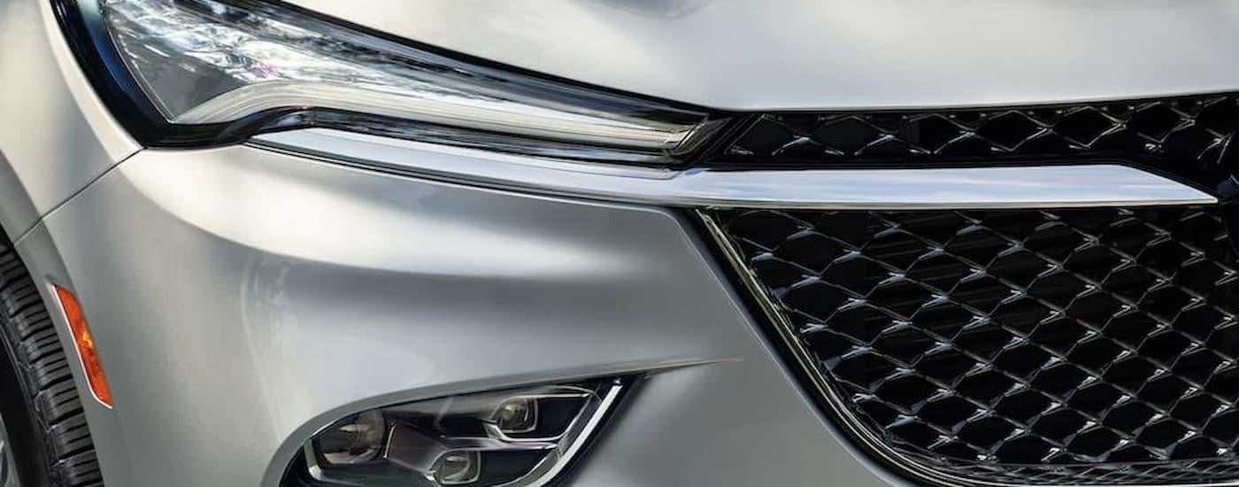 A close up of the headlight on a silver 2022 Buick Enclave Avenir is shown.