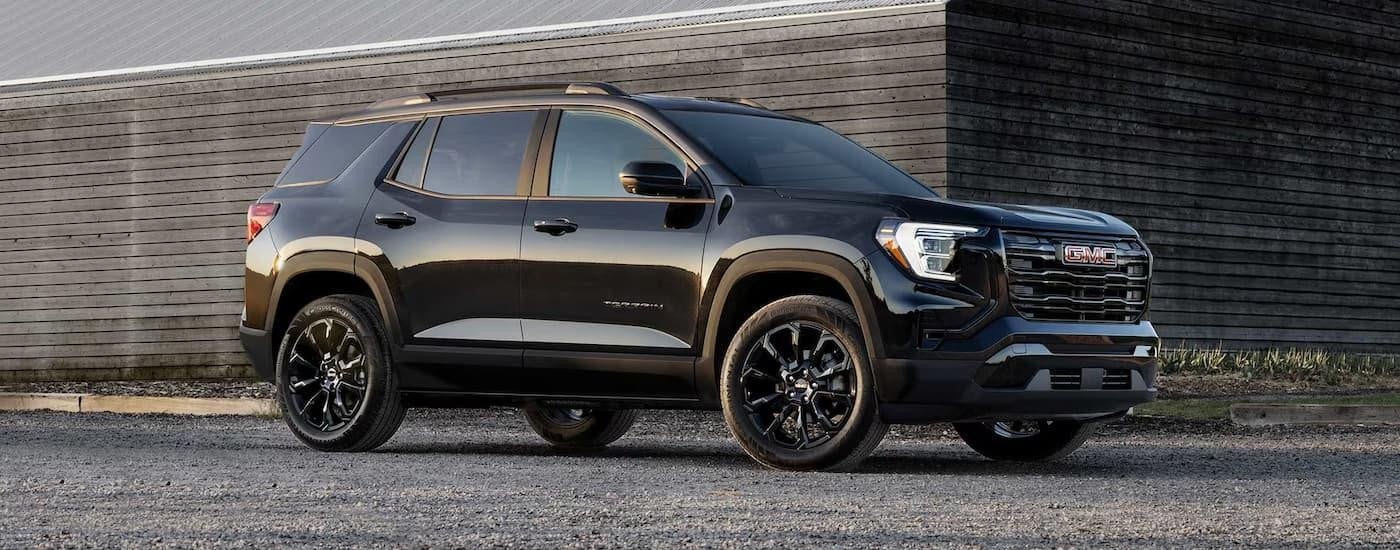 A black 2025 GMC Terrain Elevation is parked in a driveway after leaving a car dealer near you.