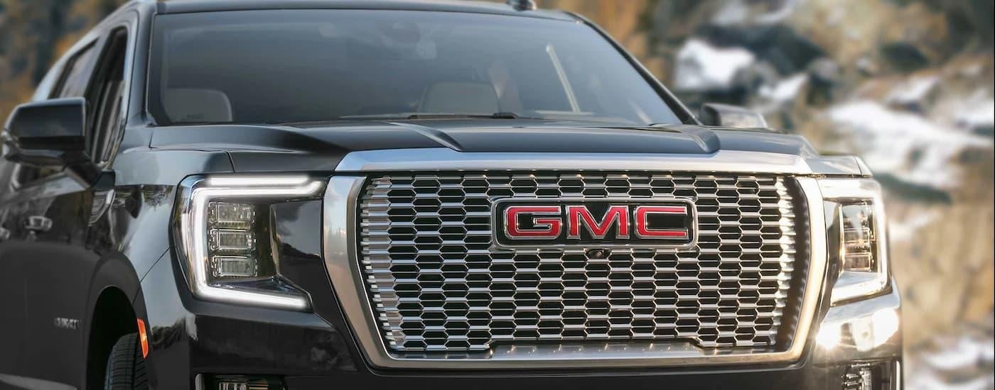 A close up of the front of a black 2023 GMC Yukon is shown.