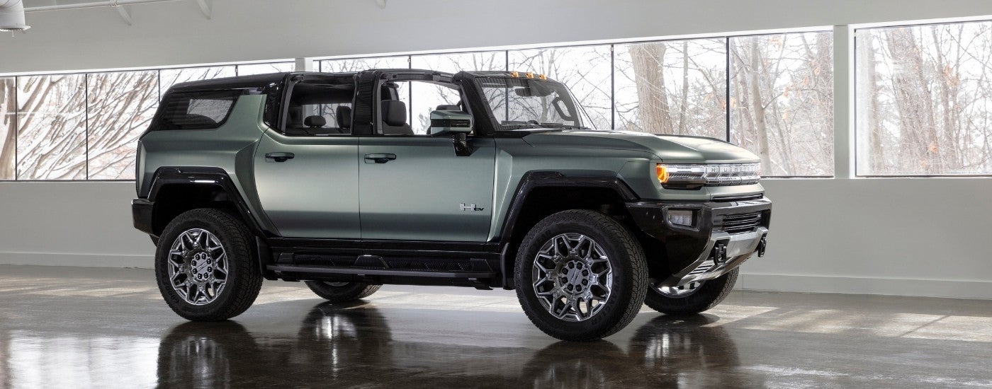 A green 2024 GMC Hummer EV is shown at a GMC dealership near Minneapolis.