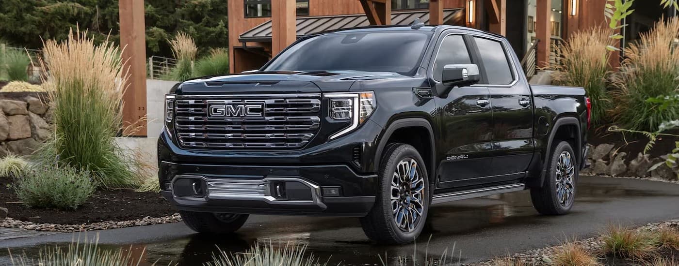 A black 2026 GMC Sierra 1500 Denali parked on a driveway.