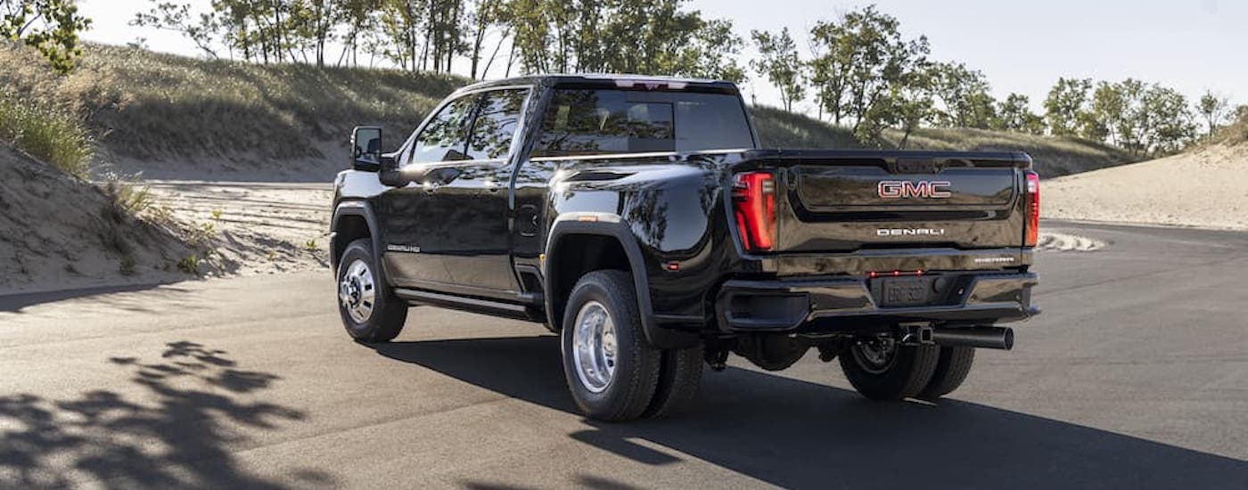 A black 2025 GMC Sierra 3500 from the rear at an angle.