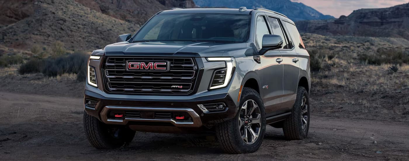 Silver 2026 GMC Yukon XL for sale parked off-road.