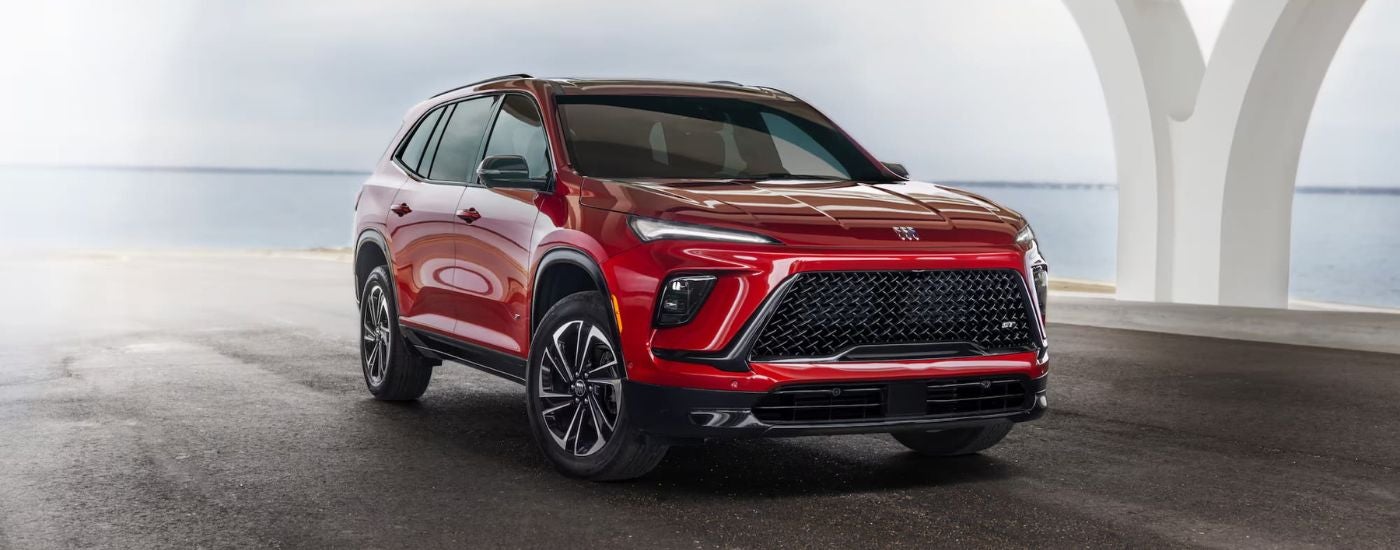 A red 2024 Buick Enclave is parked near Mankato car dealer.