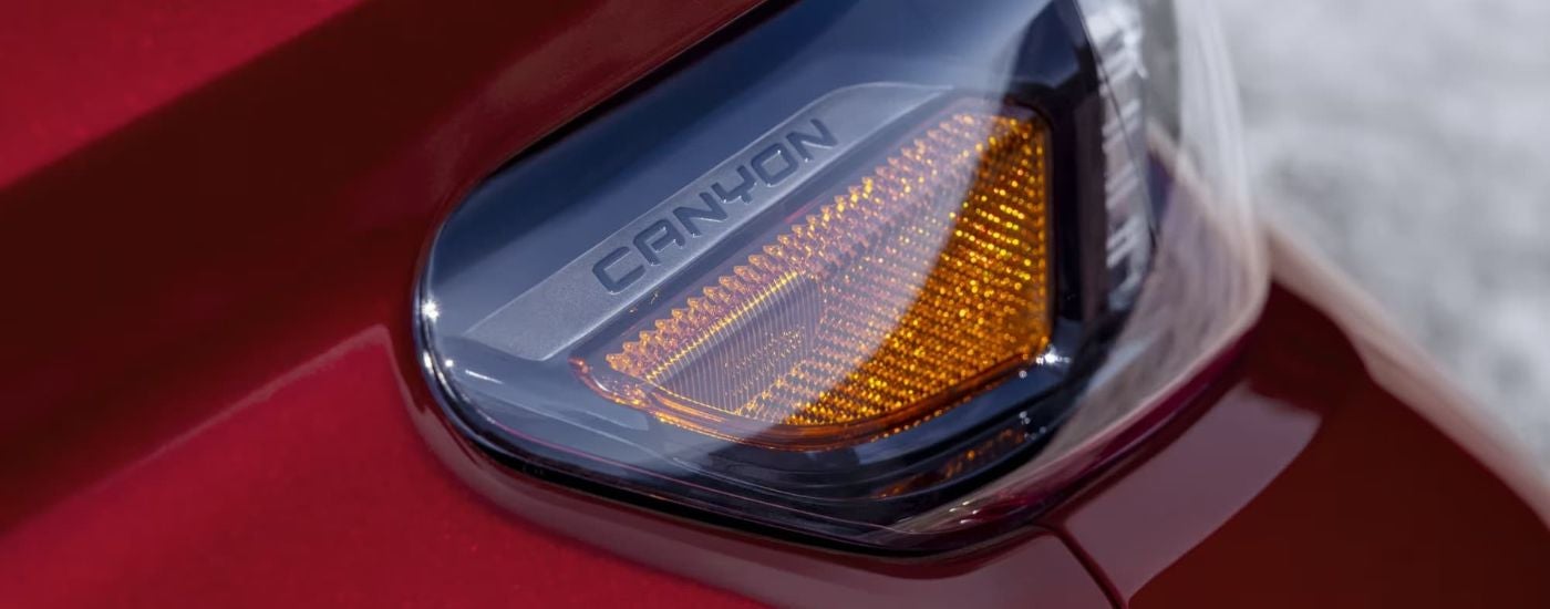 A close up shows a turn signal on a red 2023 GMC Canyon AT4X.